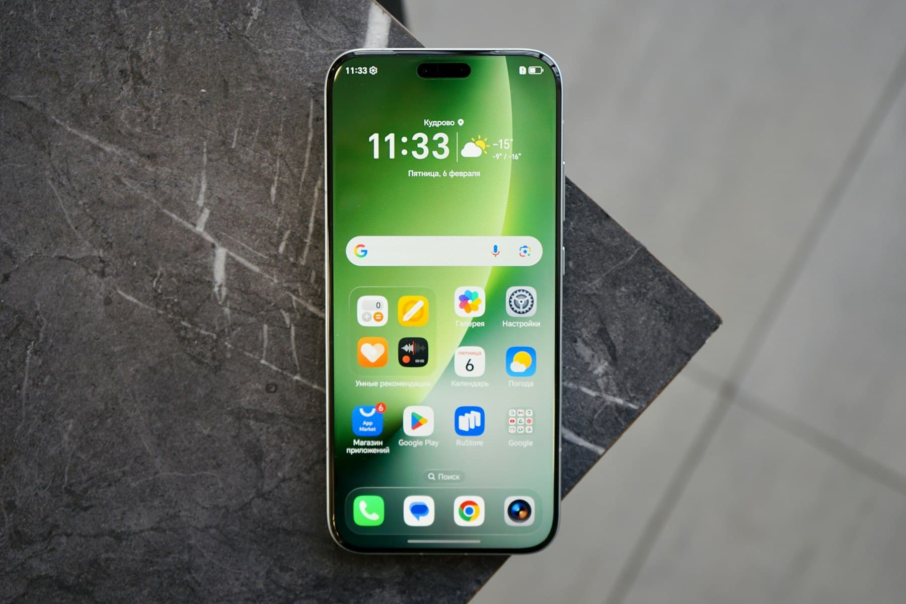 Smartphone displaying colorful app icons on a marble surface