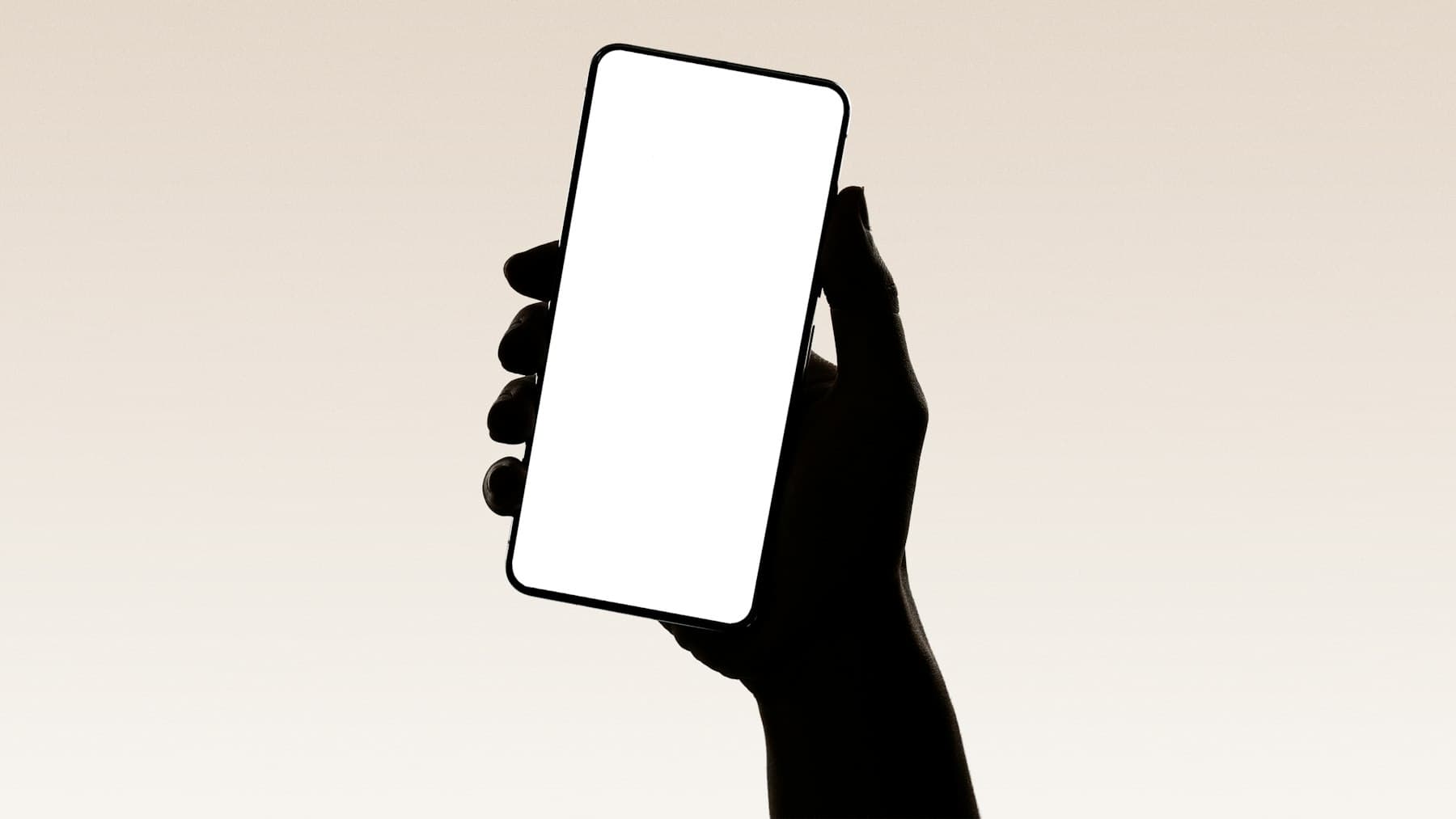 A hand holding up a smartphone displaying an app interface