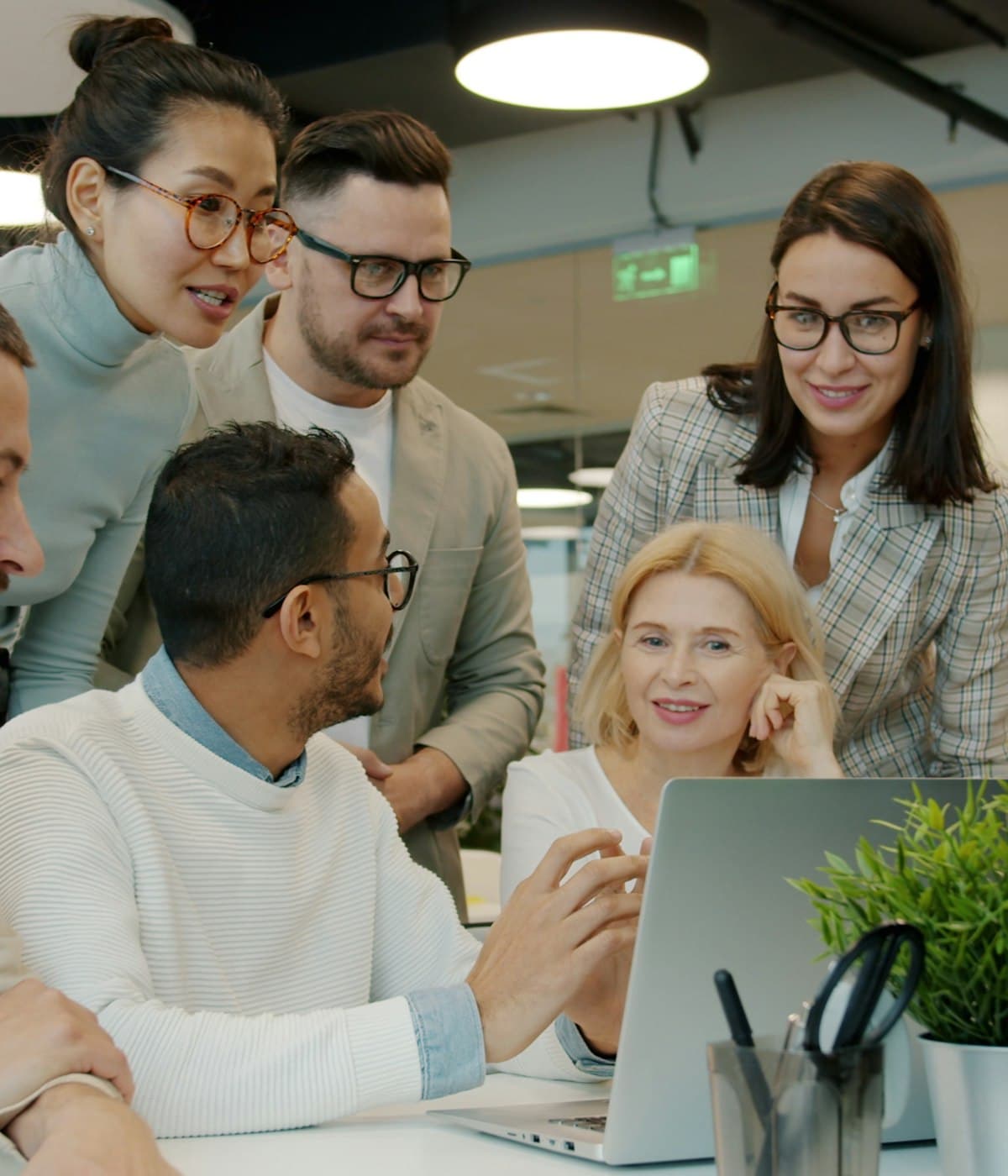 The Staller Stack team reviewing a project together around a laptop.