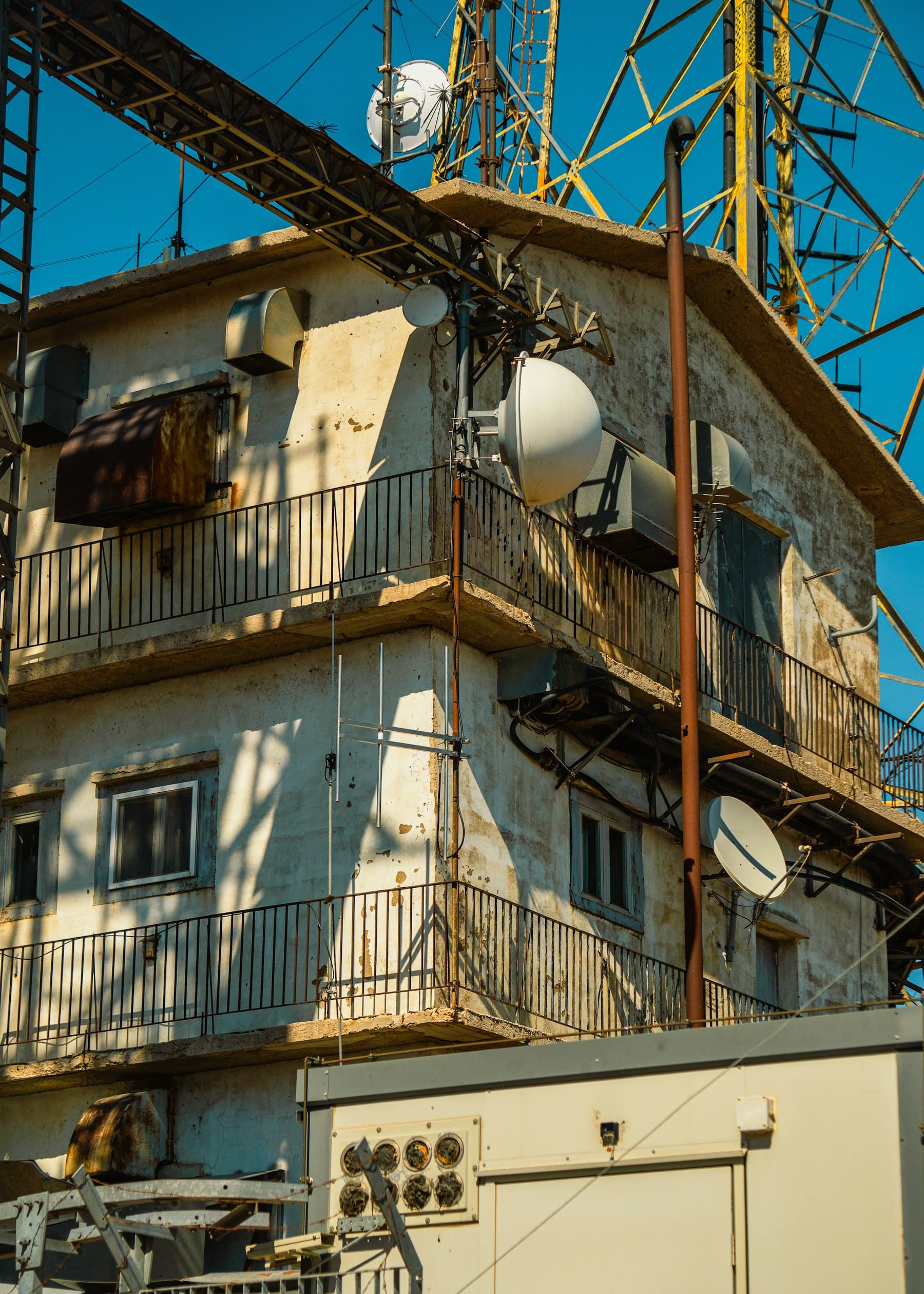 An old building with a tower and satellite dish on top