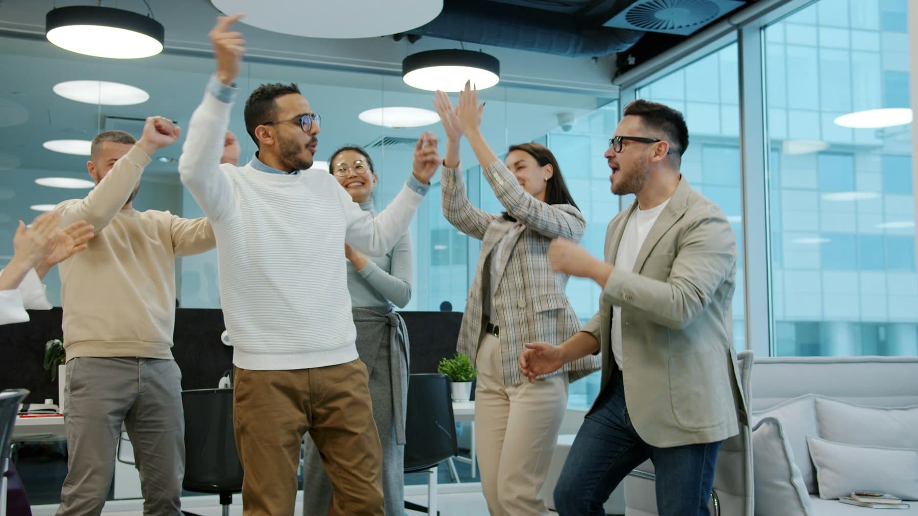 A diverse group of colleagues celebrating success in an office