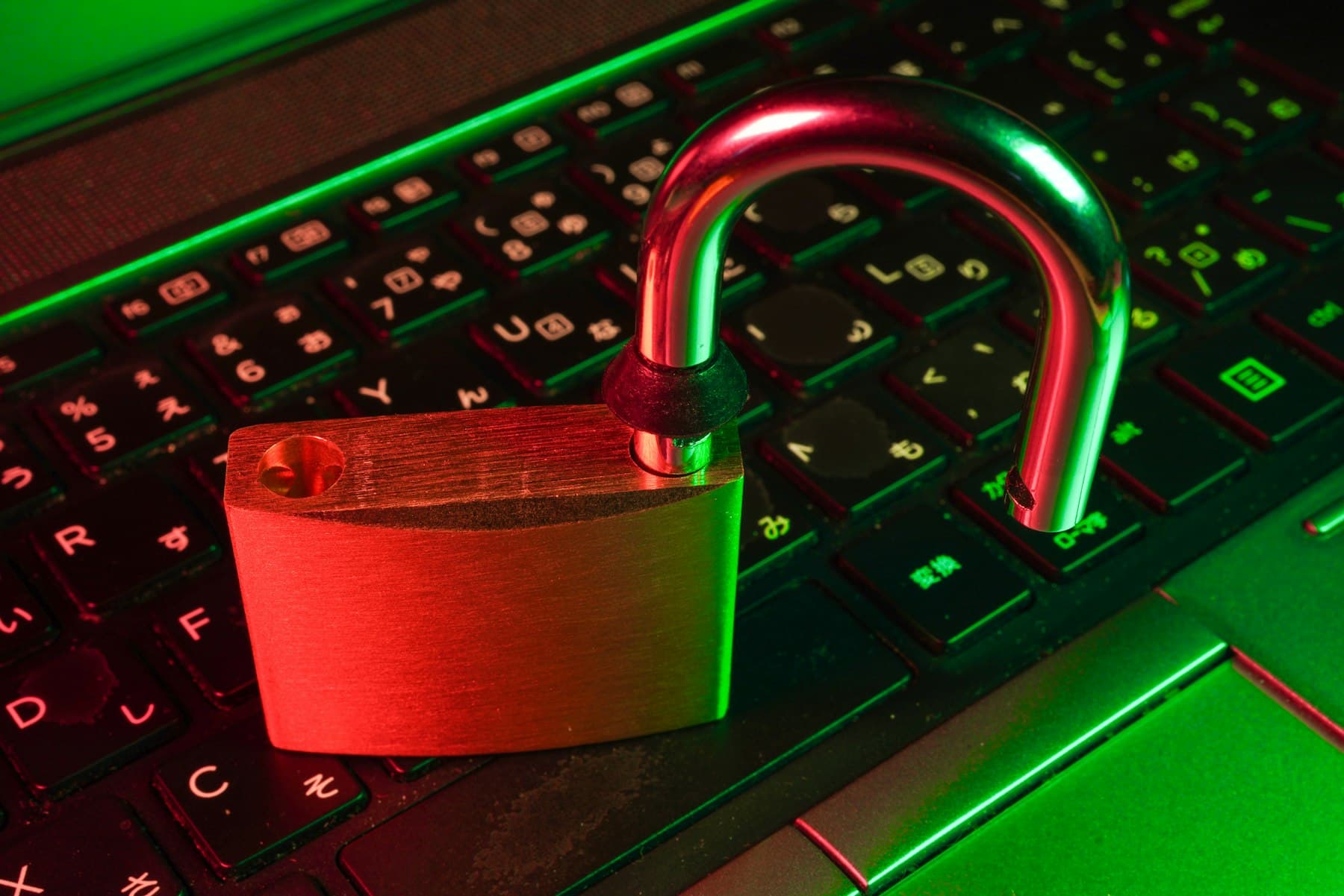 Red padlock resting on a black computer keyboard